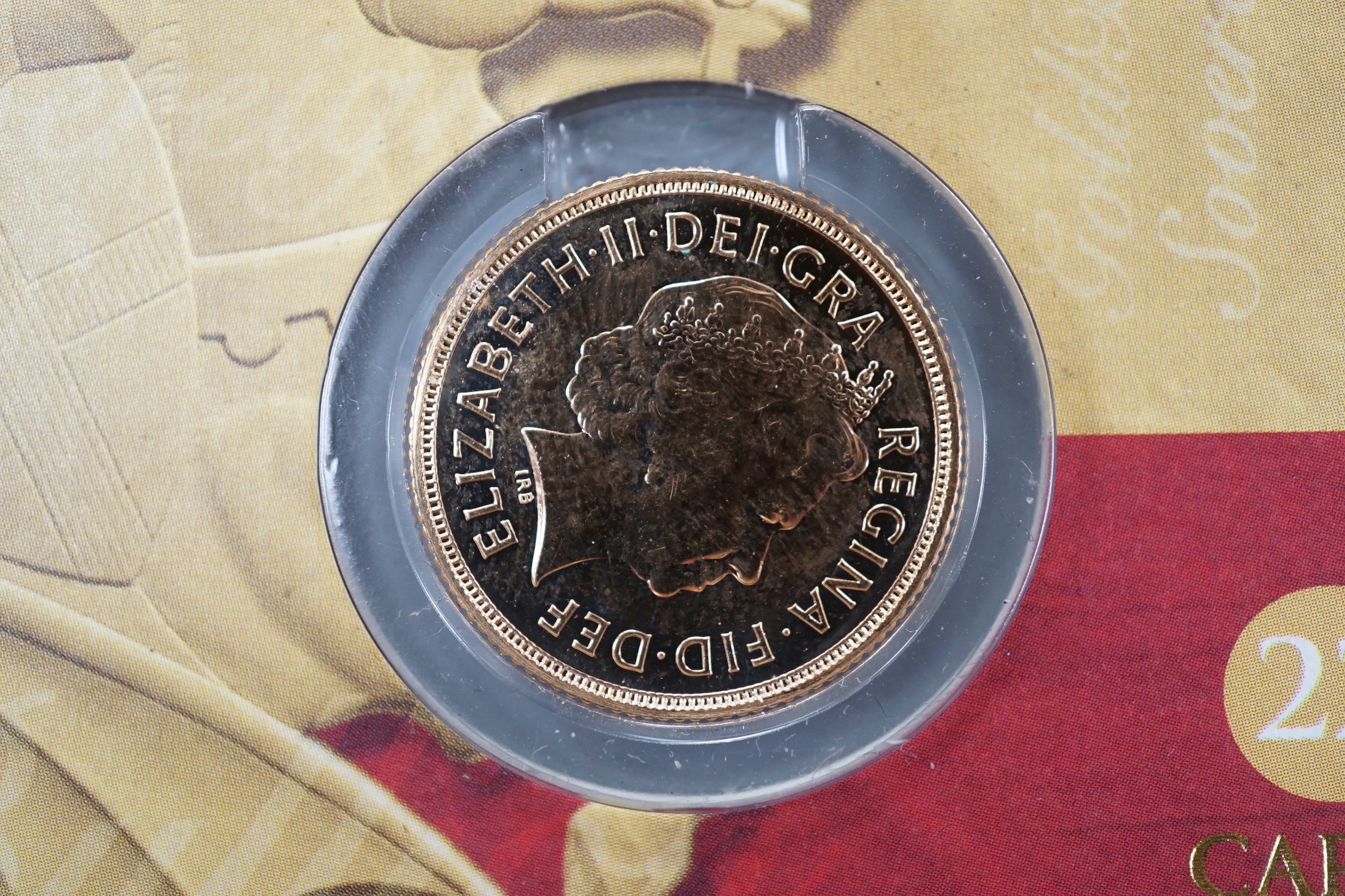 A 2005 gold sovereign, sealed in presentation card.